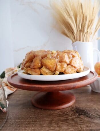 apple monkey bread on wooden cake stand