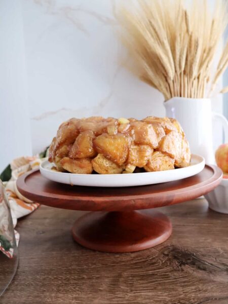 apple monkey bread on wooden cake stand