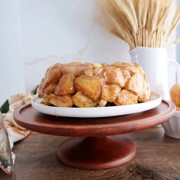 apple monkey bread on wooden cake stand