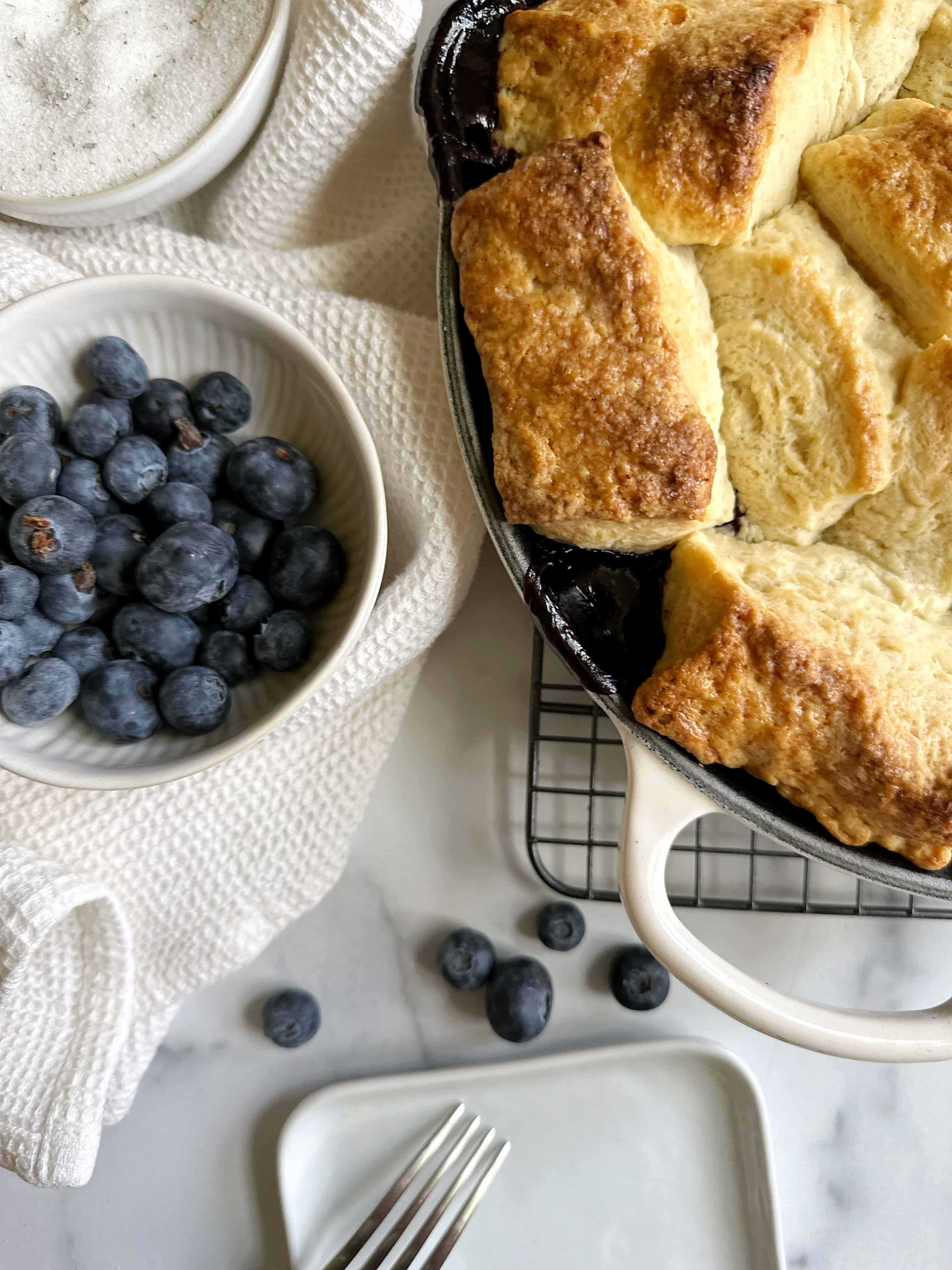 blueberry cobbler with bowl of blueberries