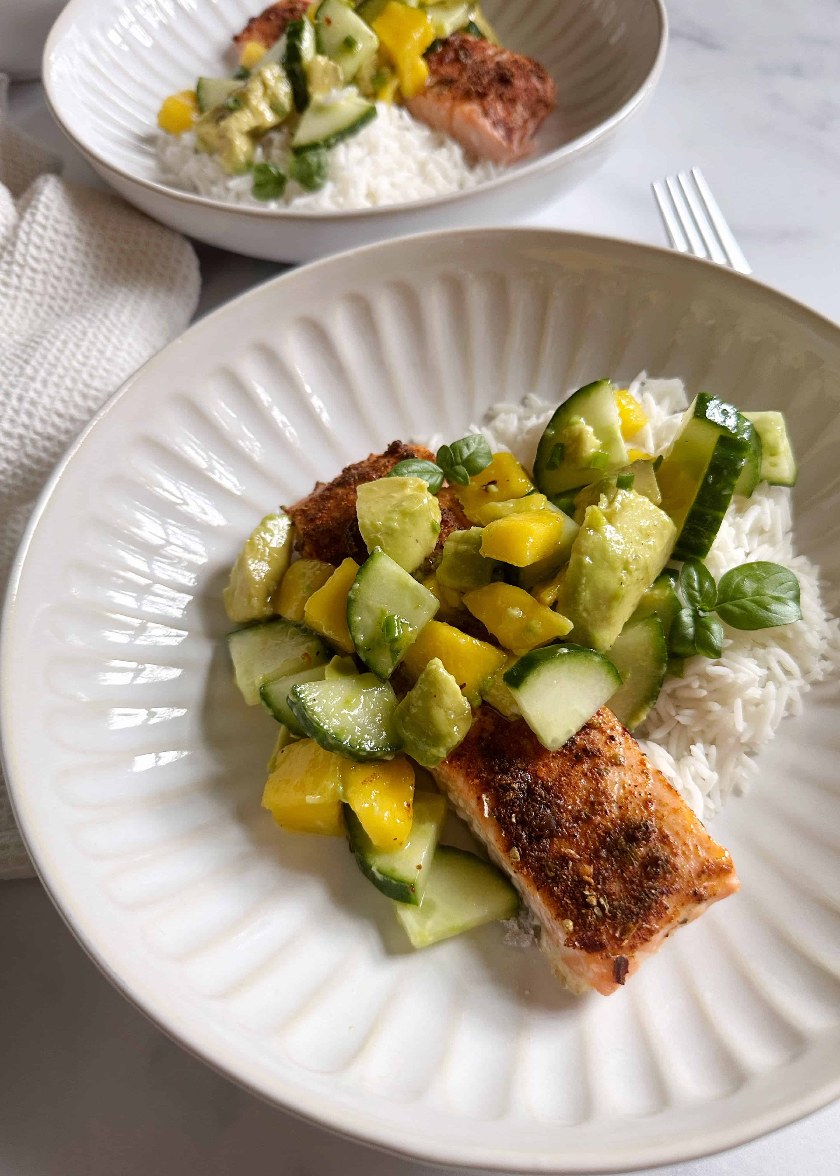 salmon with avocado cucumber salad over rice