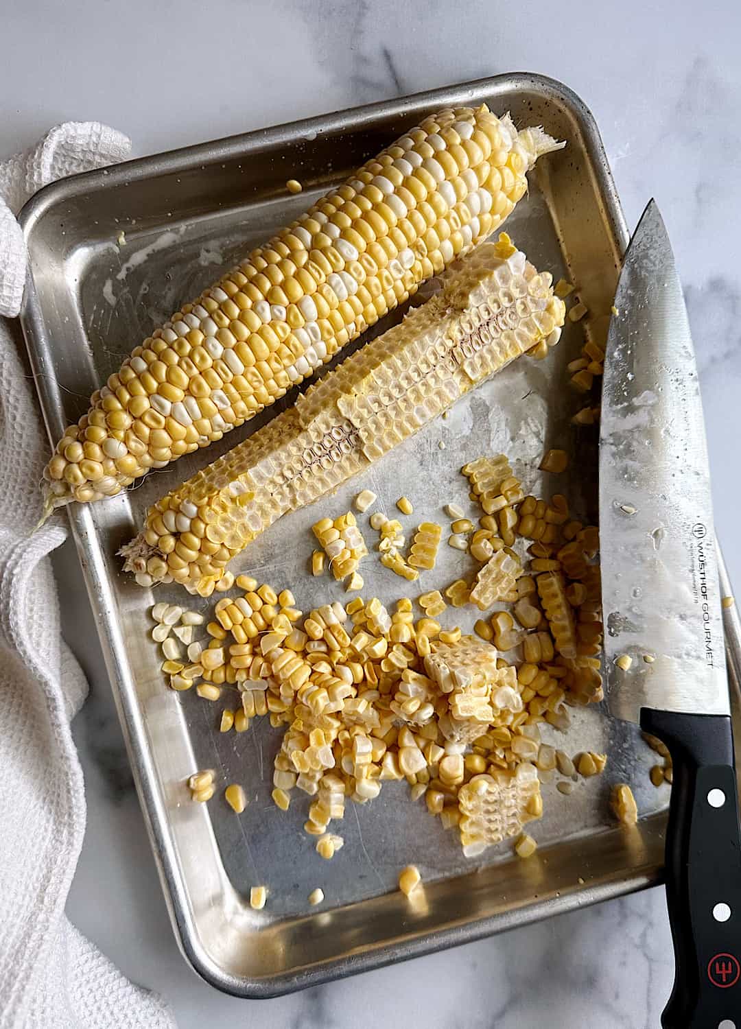 fresh corn cut off the cob on aluminum tray