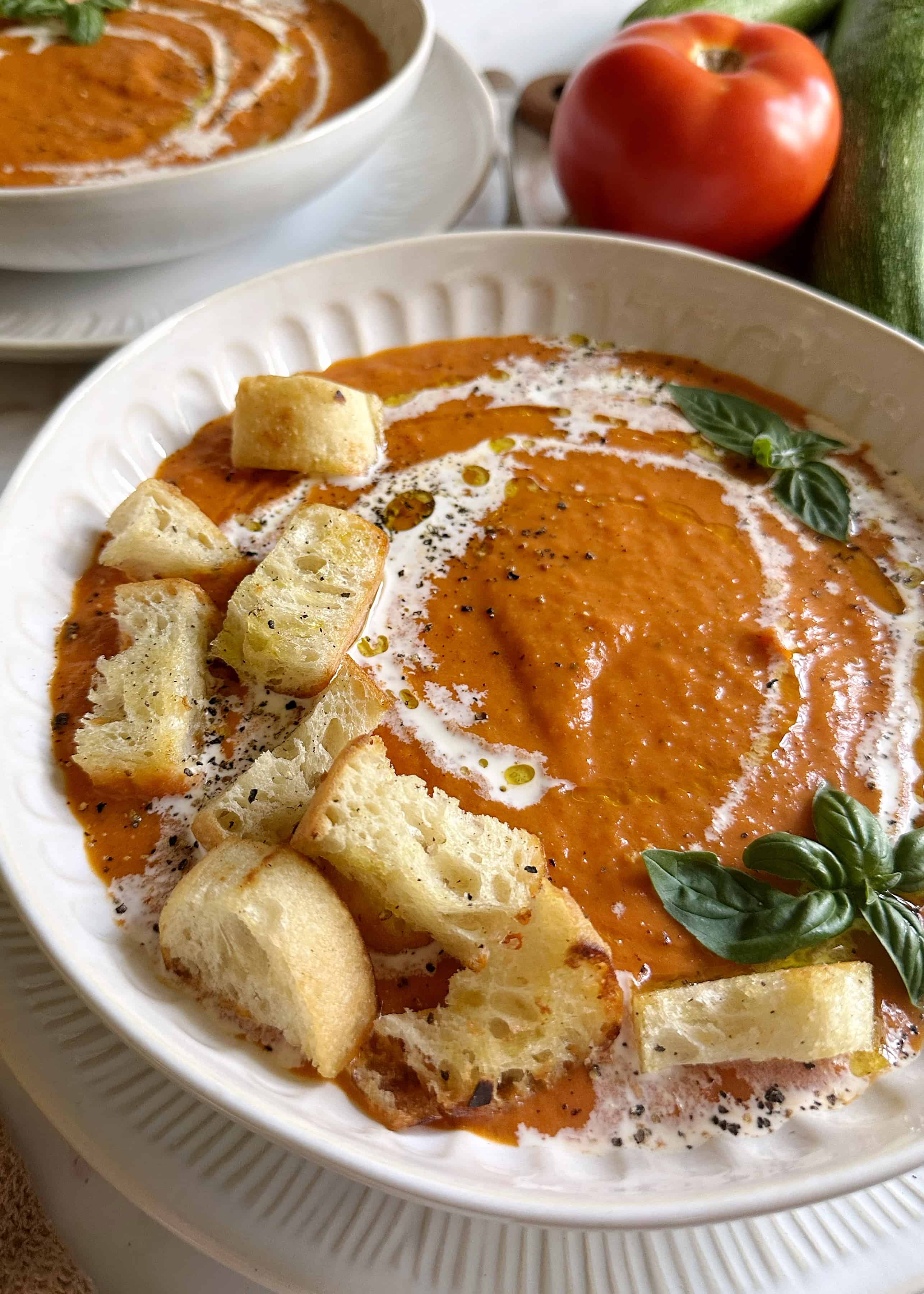 tomato zucchini soup with croutons and basil
