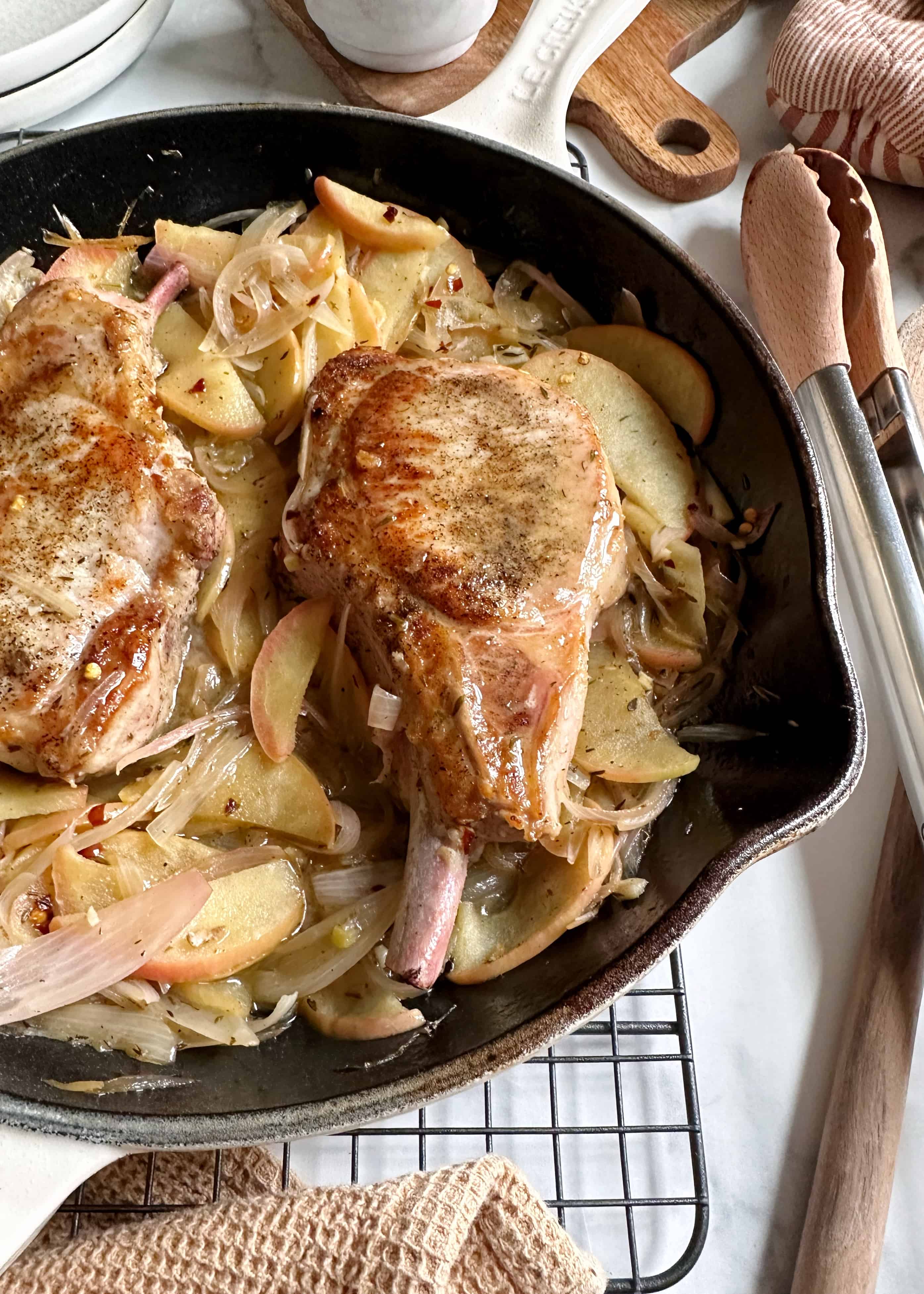 pork chops with apples and shallots in cast iron skillet