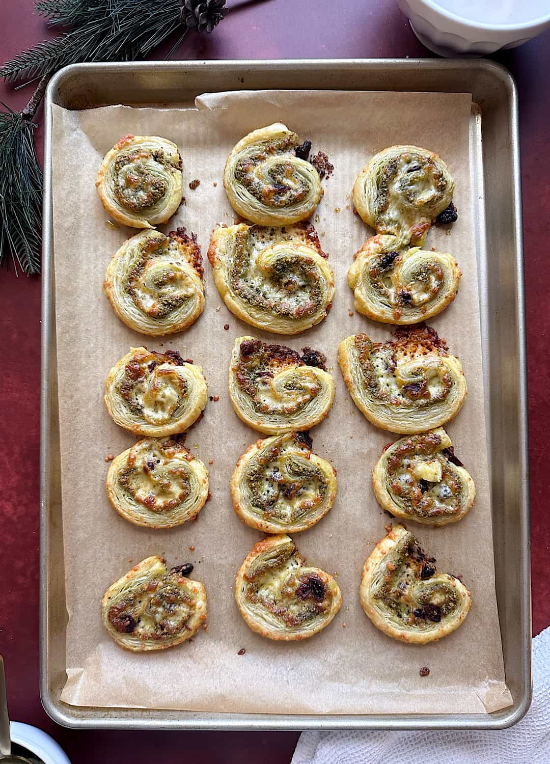 pistachio pesto cranberry pinwheel on silver baking tray