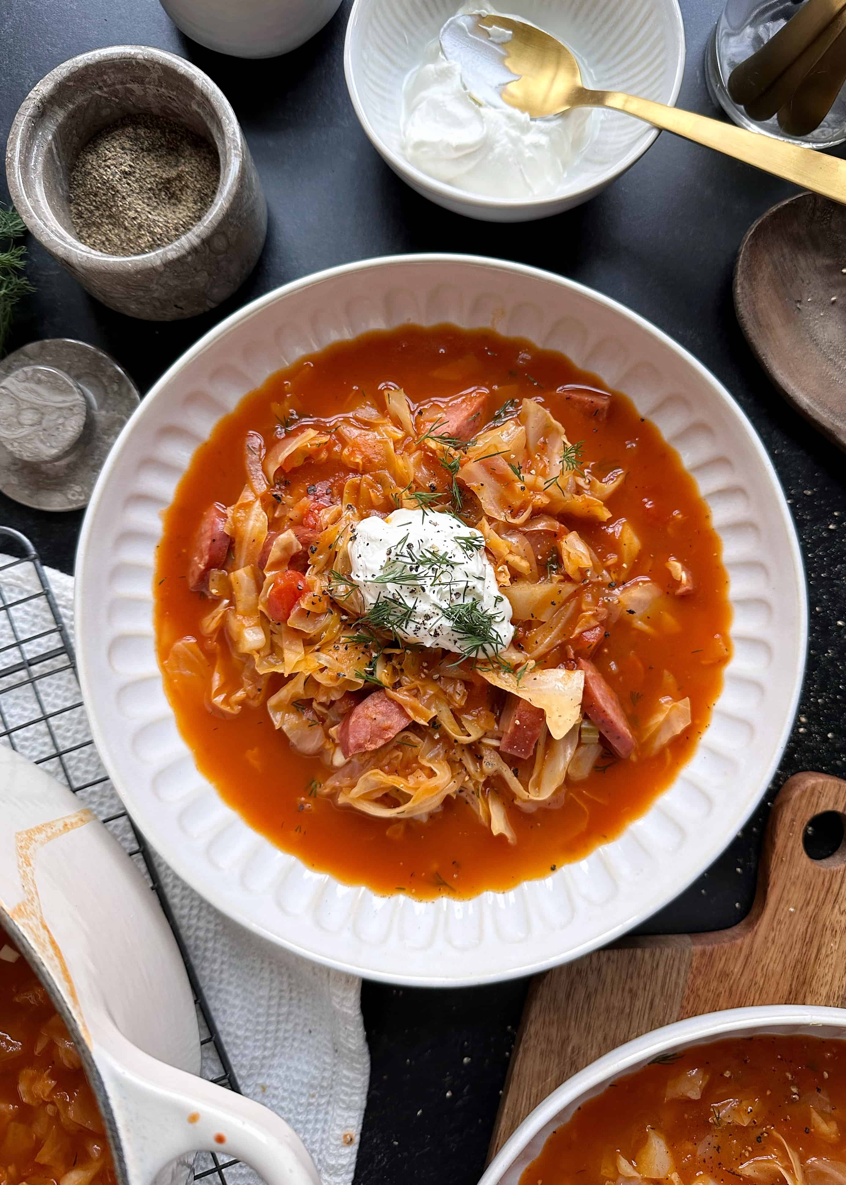 tomato cabbage kielbasa soup with sour cream and dill