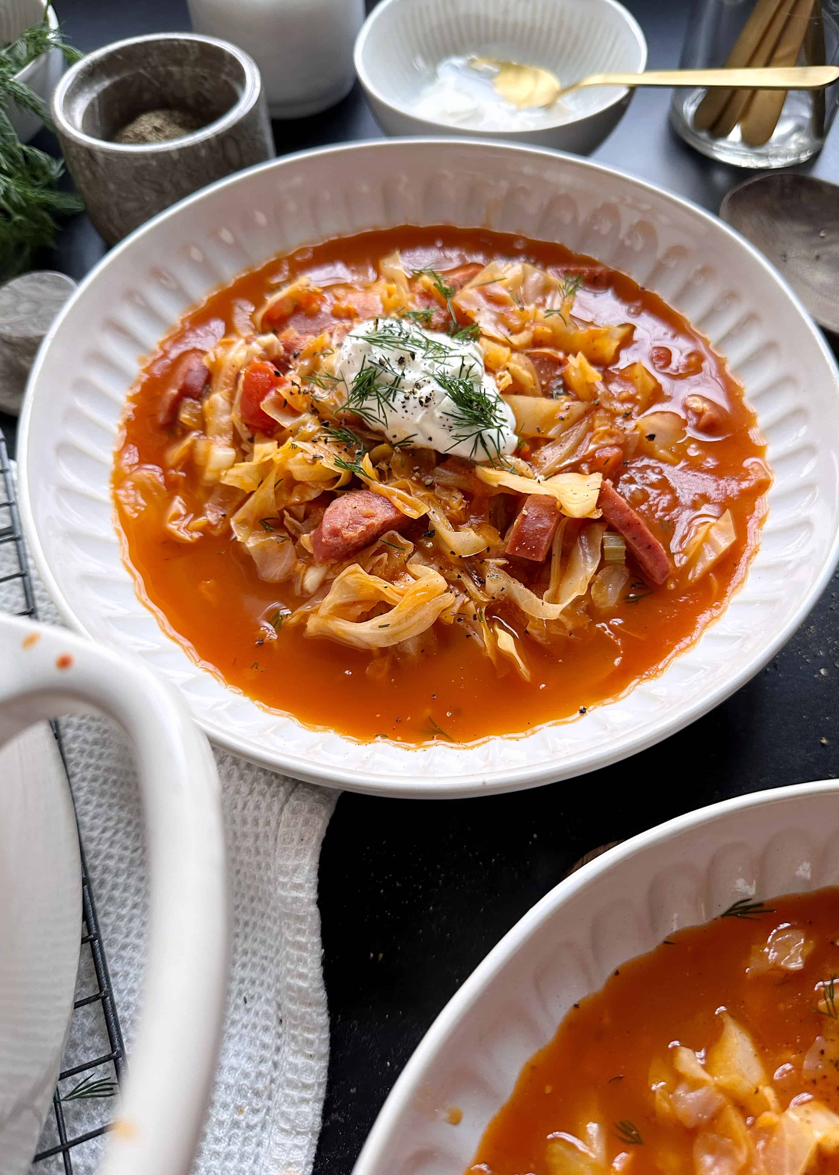 tomato cabbage kielbasa soup with garnish