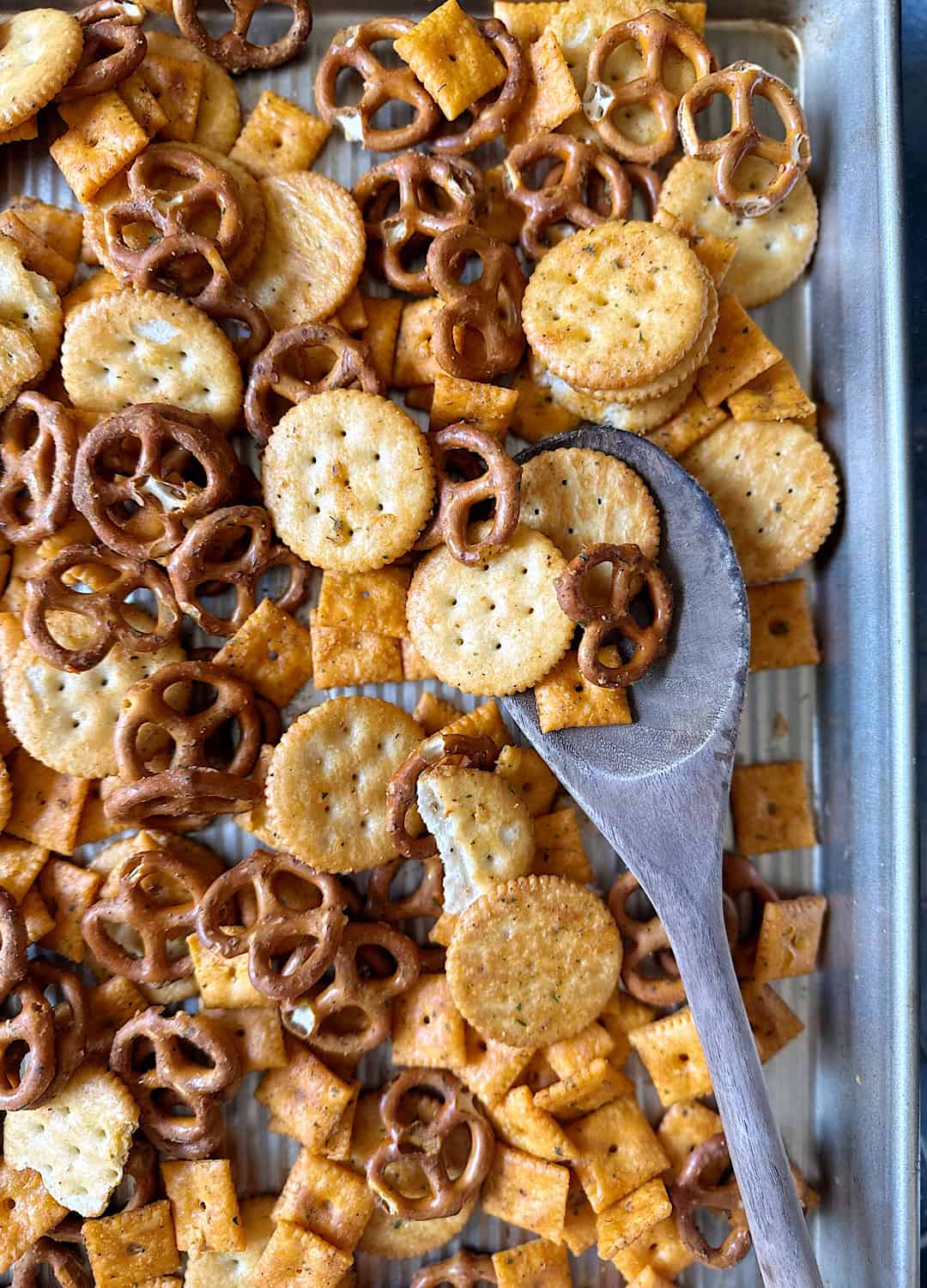 baked buffalo ranch snack mix with wooden spoon