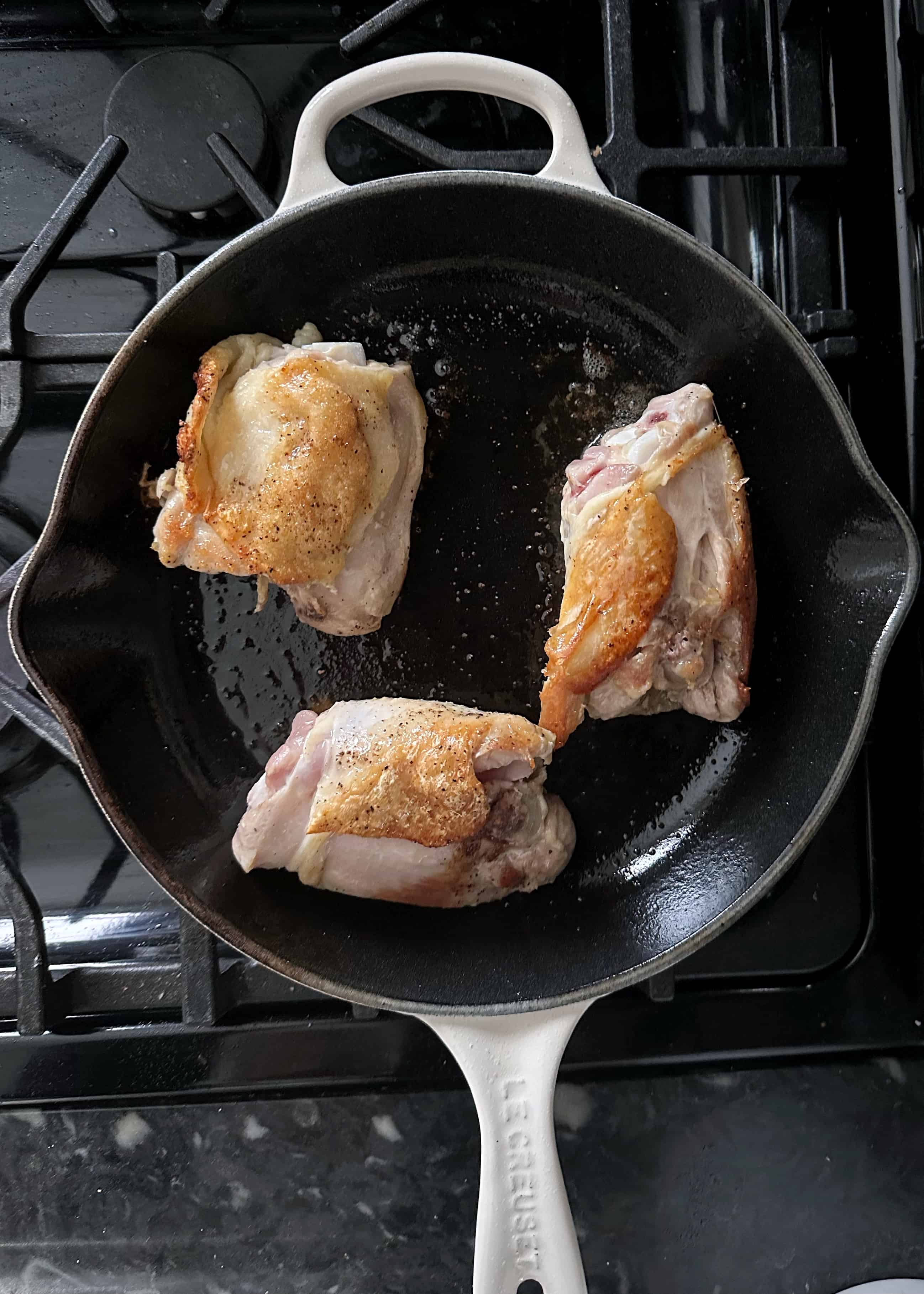 super crispy chicken thighs in a frying pan