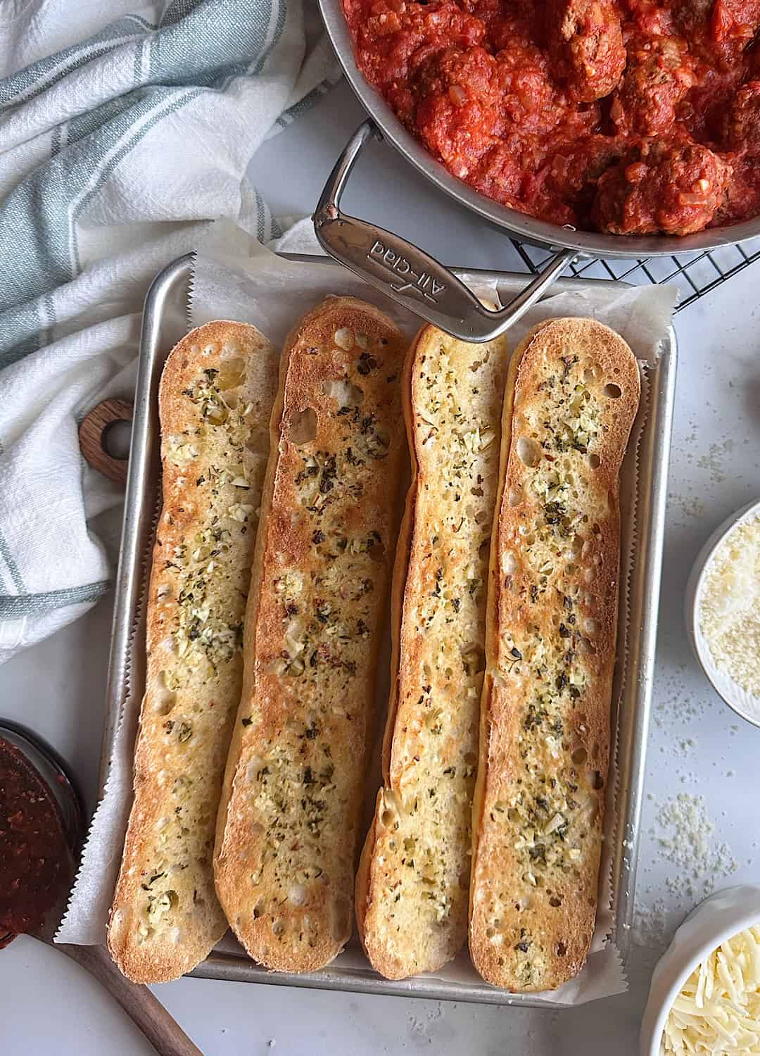 crisped garlic bread with meatballs on the side