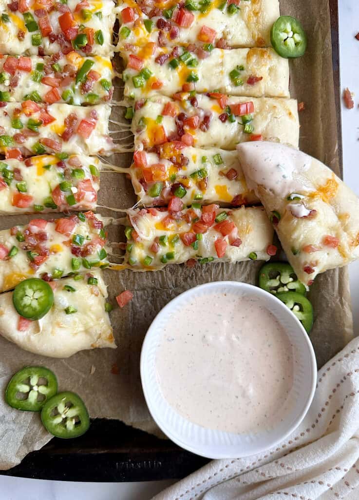 jalapeno popper breadsticks with one dipped in bbq ranch