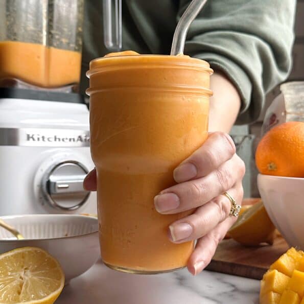 mango orange carrot smoothie in a glass