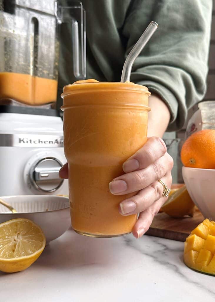 mango orange carrot smoothie in a glass