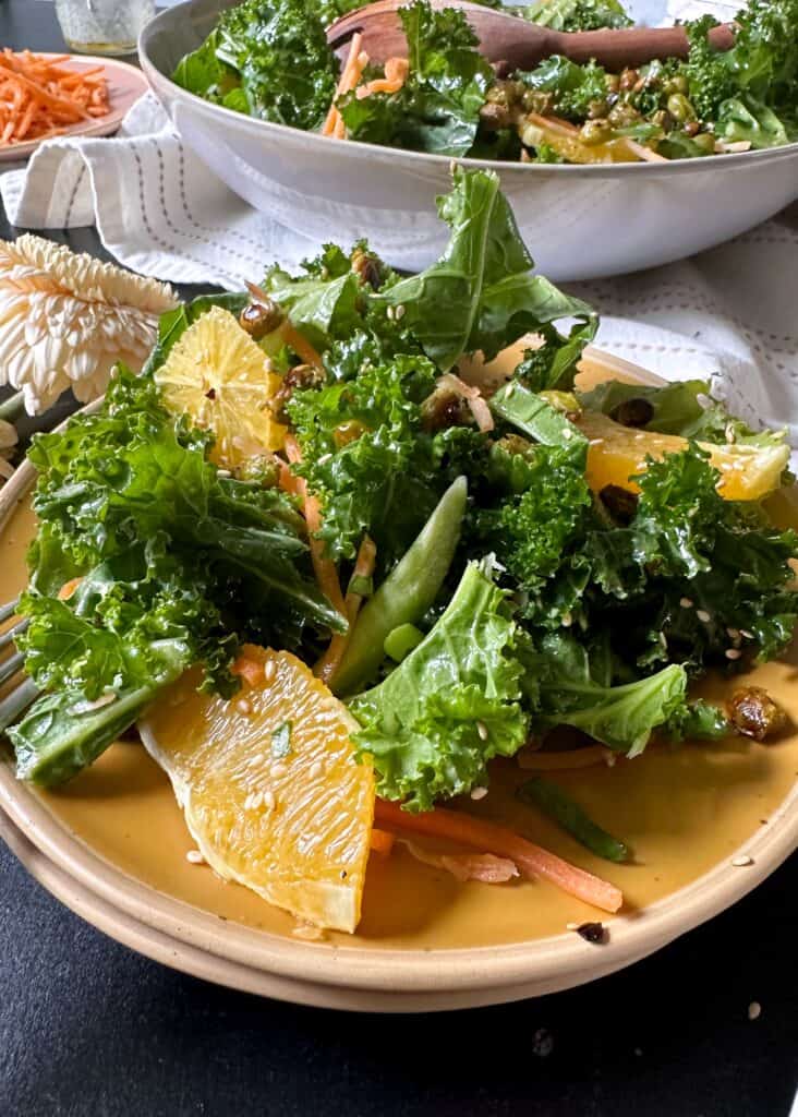 plate of kale orange salad with crispy edamame