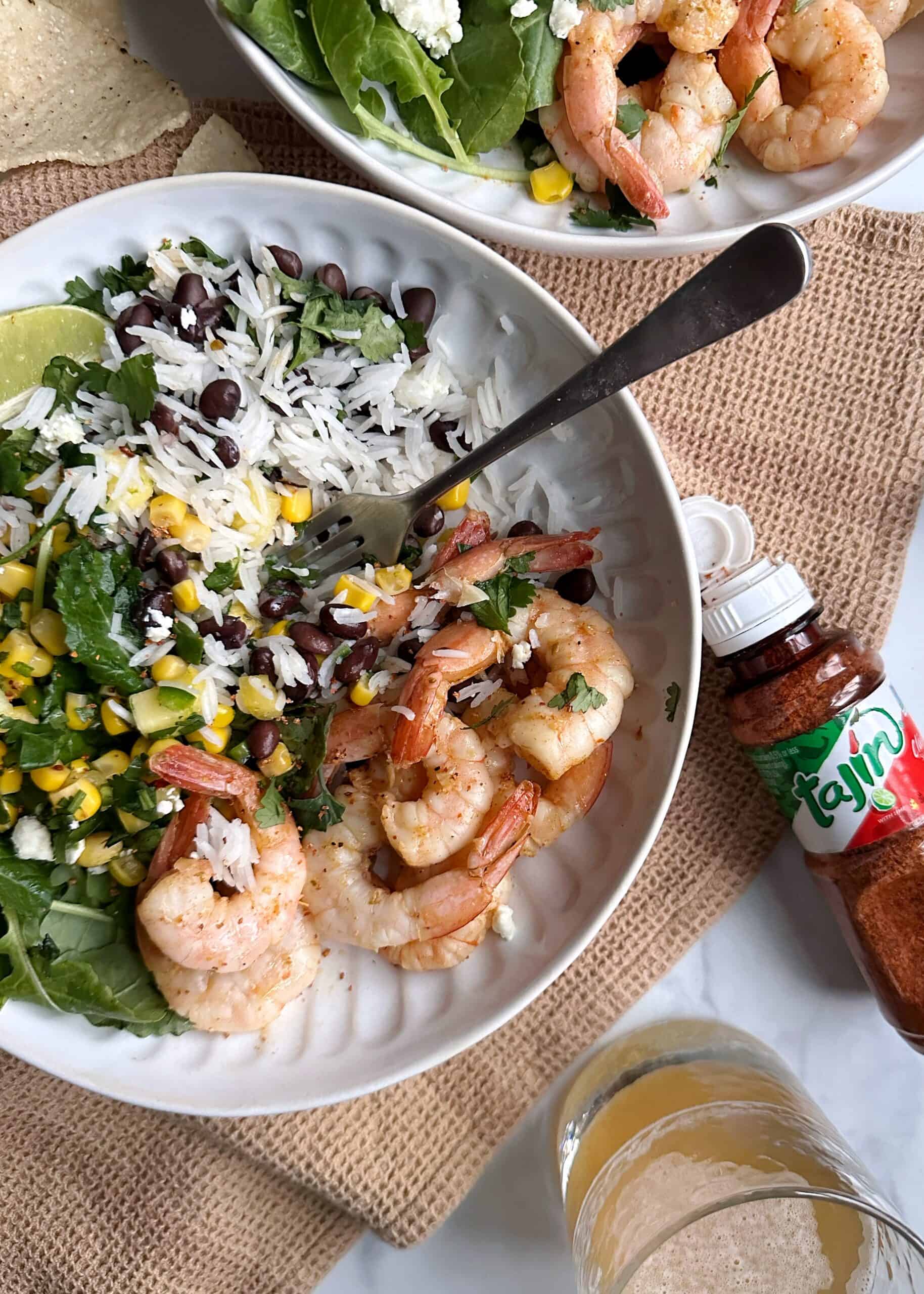 shrimp burrito bowl with pineapple corn salsa with a fork