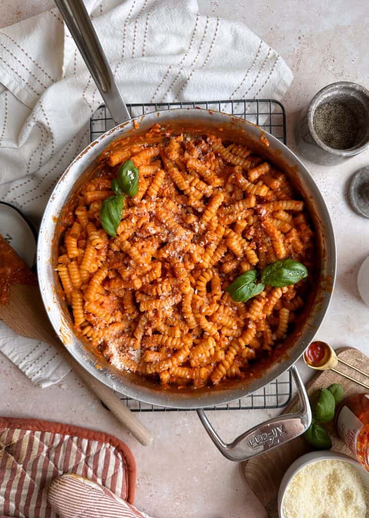 calabrian chili pasta alla vodka in saute pan with parmesan and fresh basil