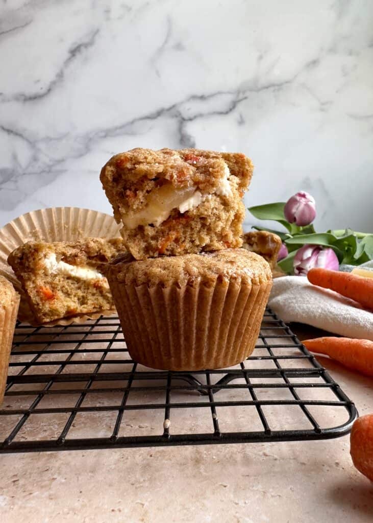 carrot ginger muffins with cream cheese center stacked on top of each other