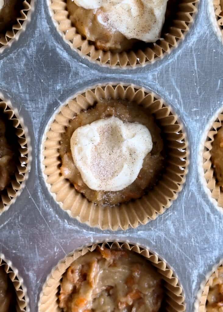 cream cheese filling in carrot muffins with cinnamon sugar