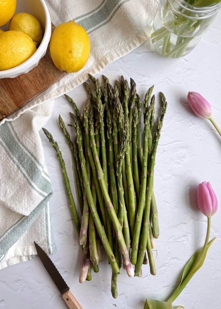 fresh asparagus with lemons and tulips