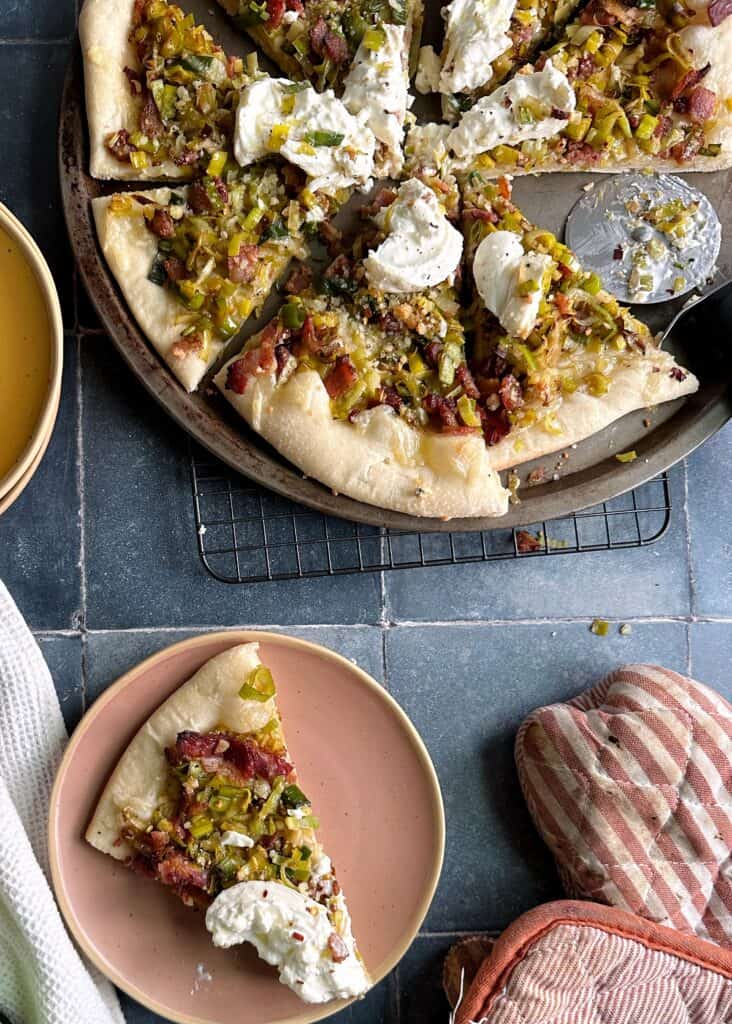 leek bacon burrata pizza with a slice on the side