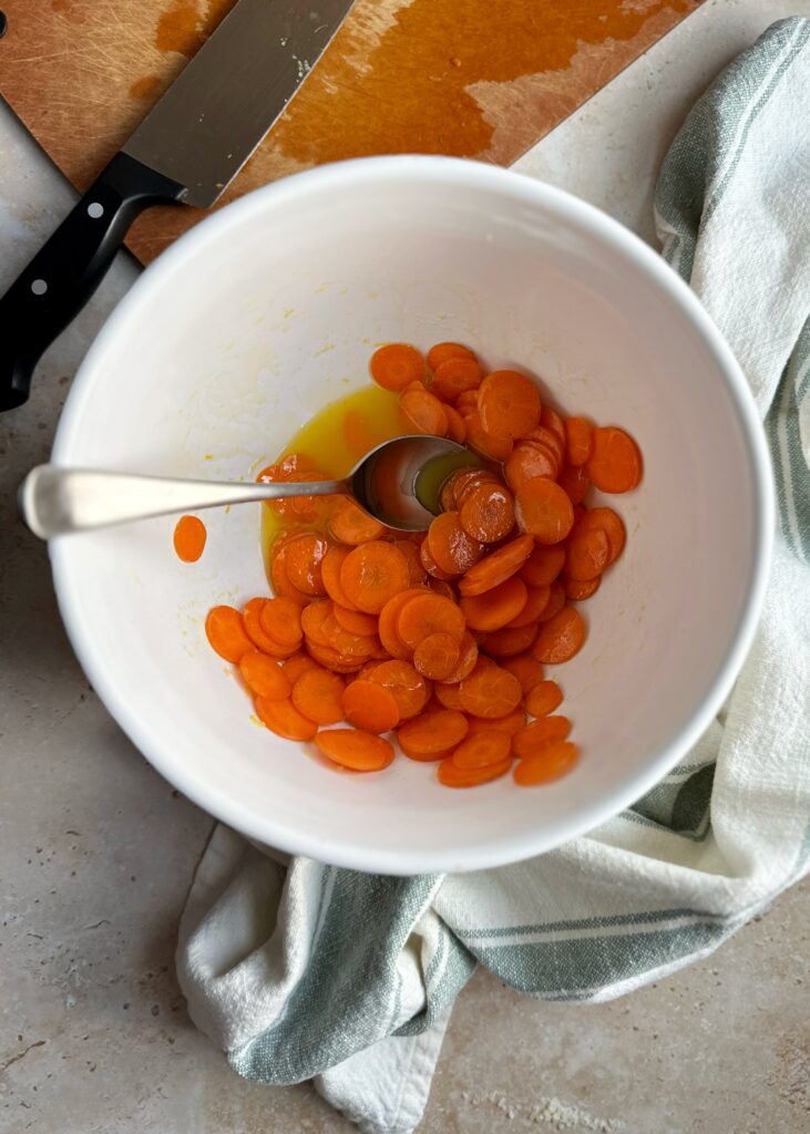 marinating carrot slices in white bowl