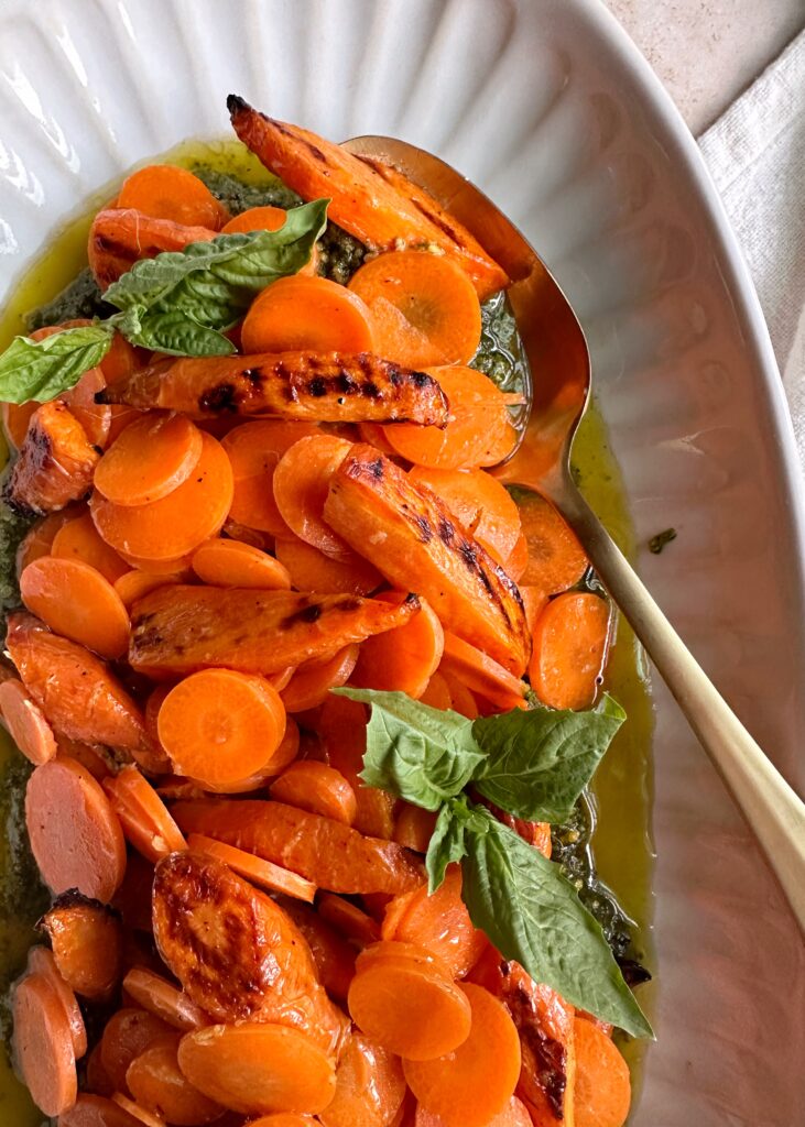 raw and roasted carrot salad with pesto and basil leaves