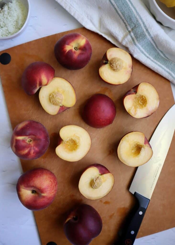 halved peaches on a cutting board