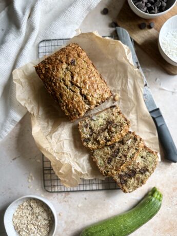 baked zucchini bread with oatmeal coconut and chocolate chips slicd on a cooling rack