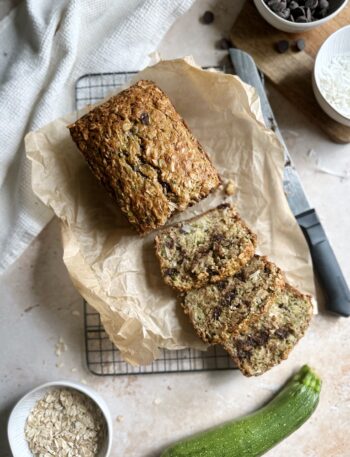 baked zucchini bread with oatmeal coconut and chocolate chips slicd on a cooling rack