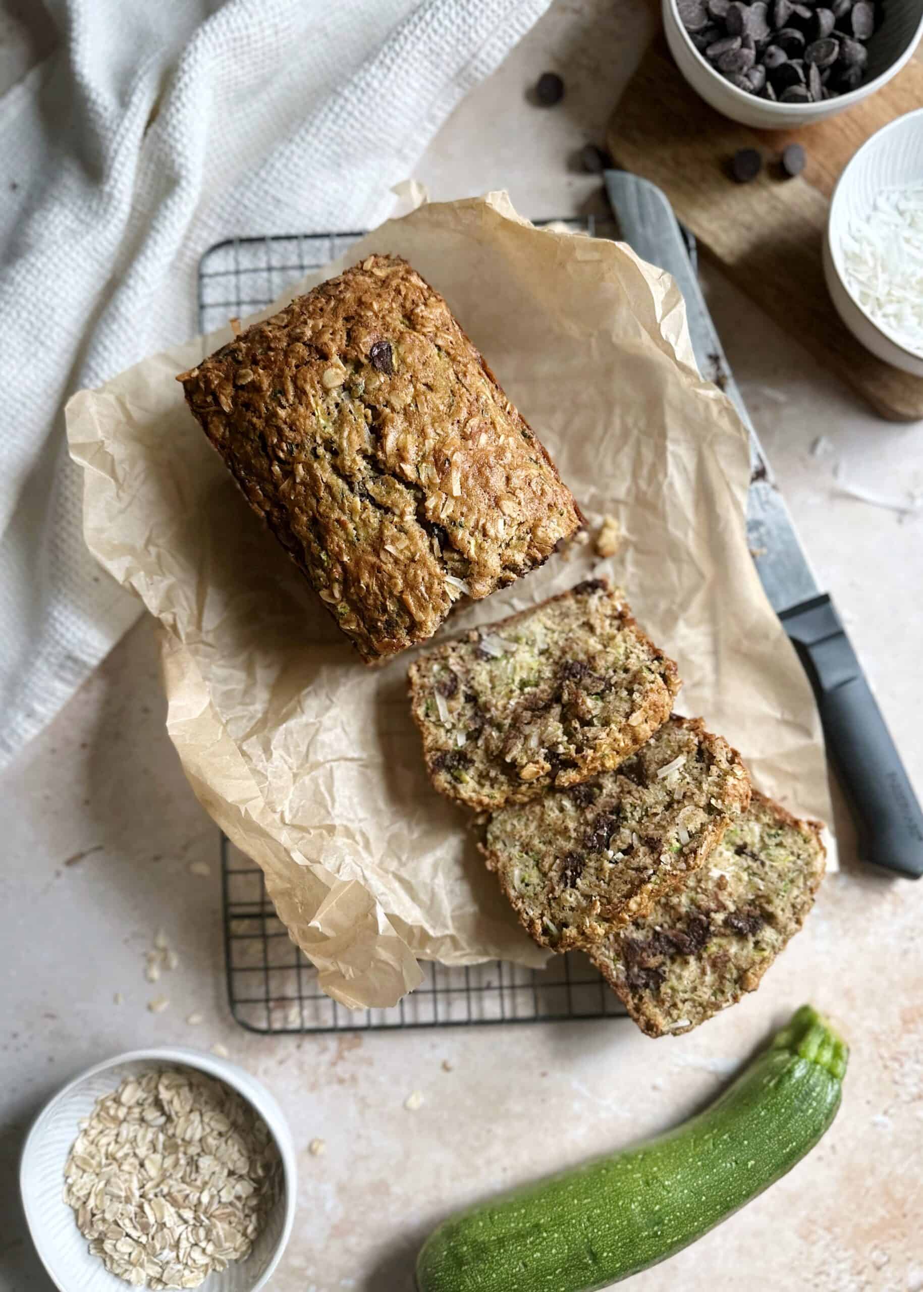 baked zucchini bread with oatmeal coconut and chocolate chips slicd on a cooling rack