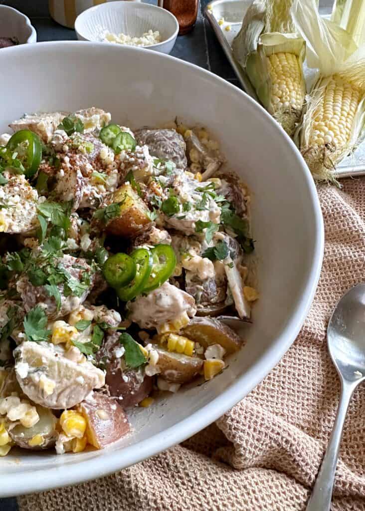 corn and potato salad in white serving bowl