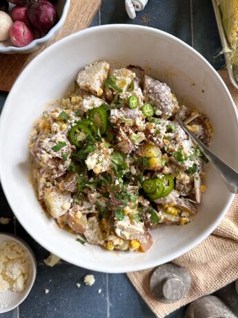 elote potato salad in white serving bowl