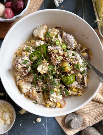 elote potato salad in white serving bowl