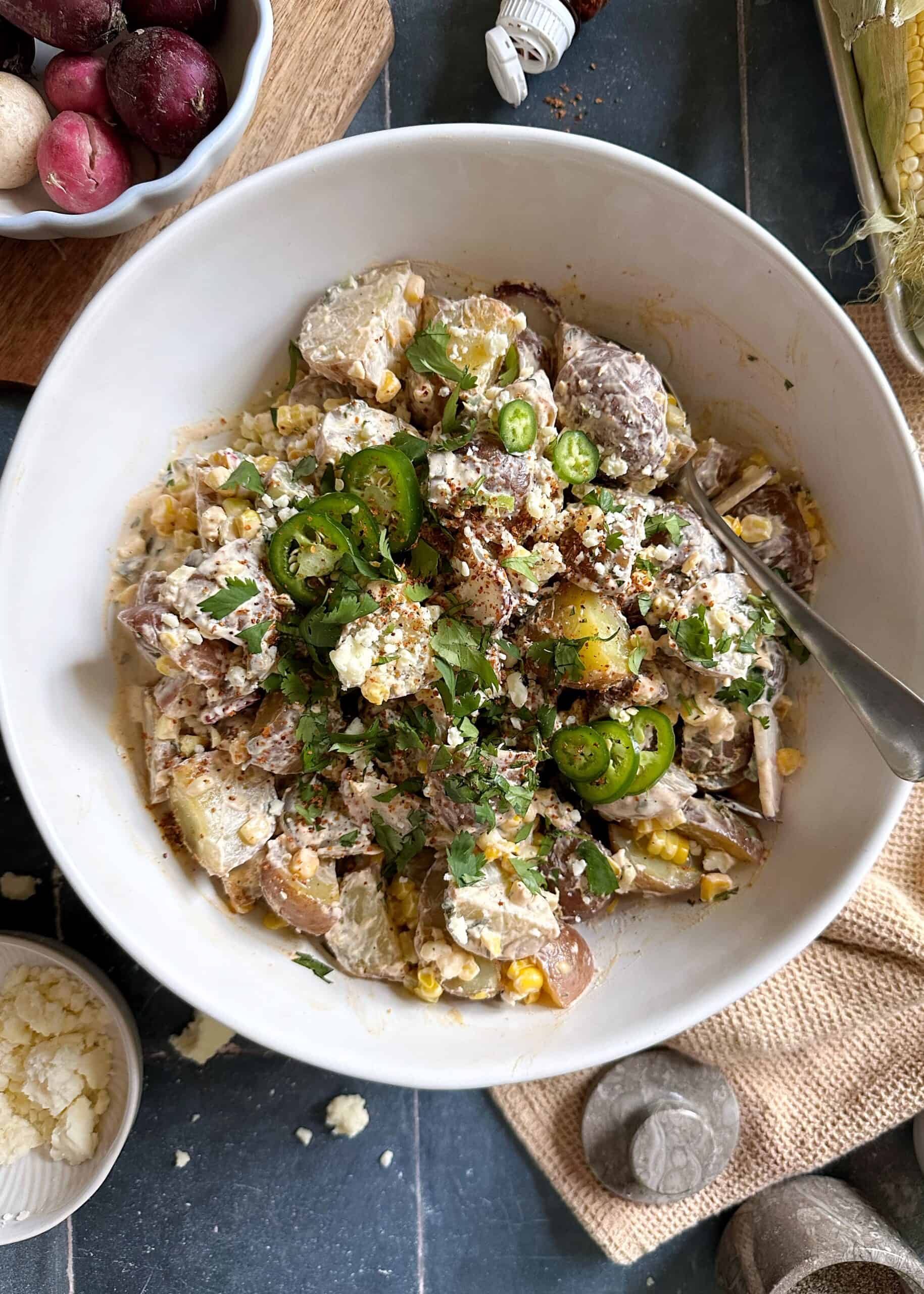 elote potato salad in white serving bowl