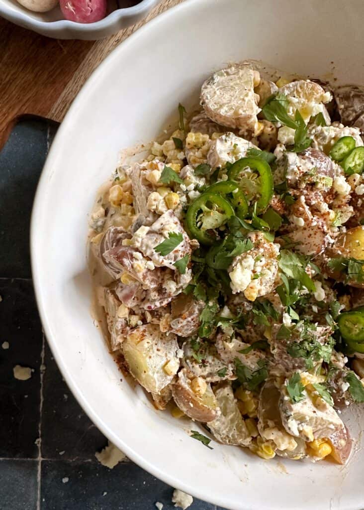 elote potato salad with cilantro cotija and tajin garnish