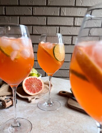 three glasses of aperol paloma spritzes