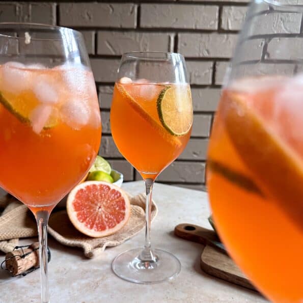 three glasses of aperol paloma spritzes