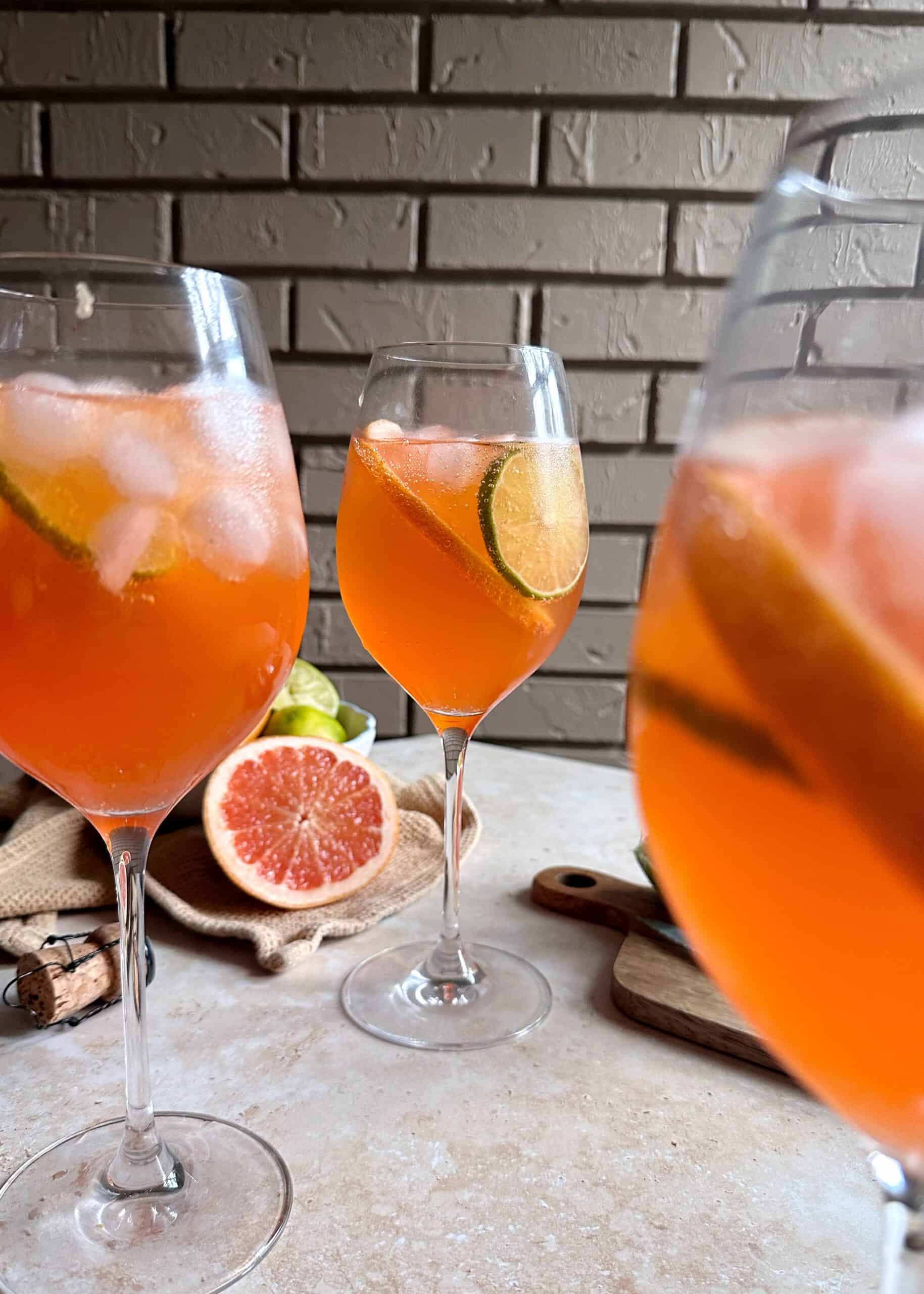 three glasses of aperol paloma spritzes