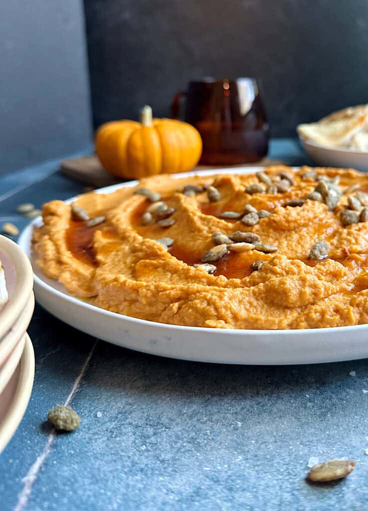 pumpkin hummus on a white plate