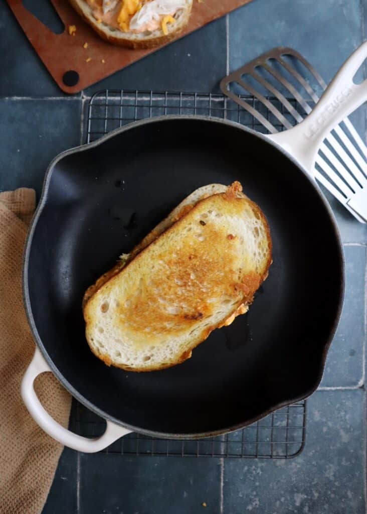 buffalo chicken grilled cheese in a cast iron skillet