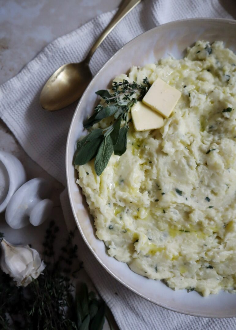 buttery garlic and herb mashed potatoes with herb garnish