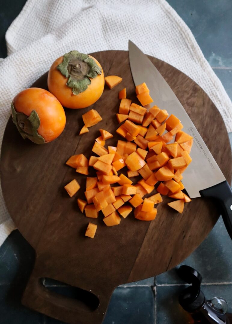 chopped persimmons on a wooden cutting board