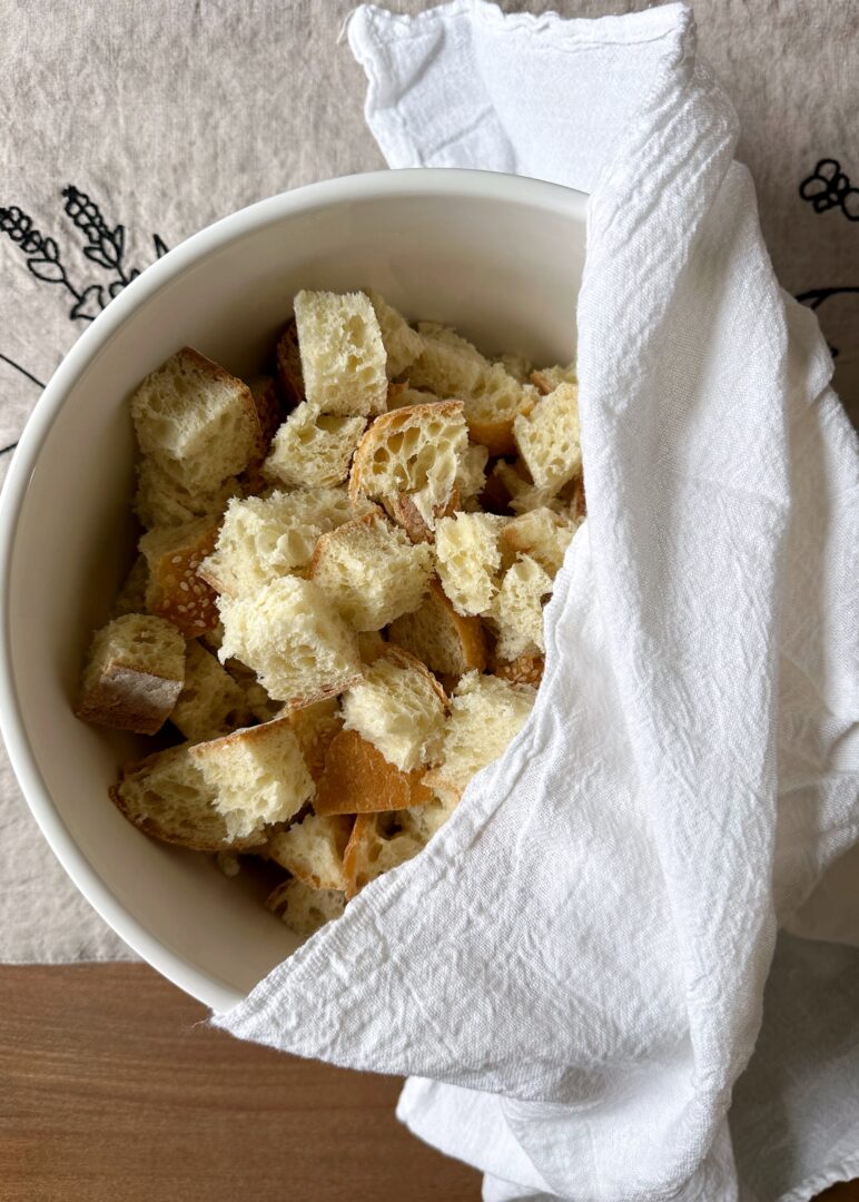 cubed bread in white bowl with white towel