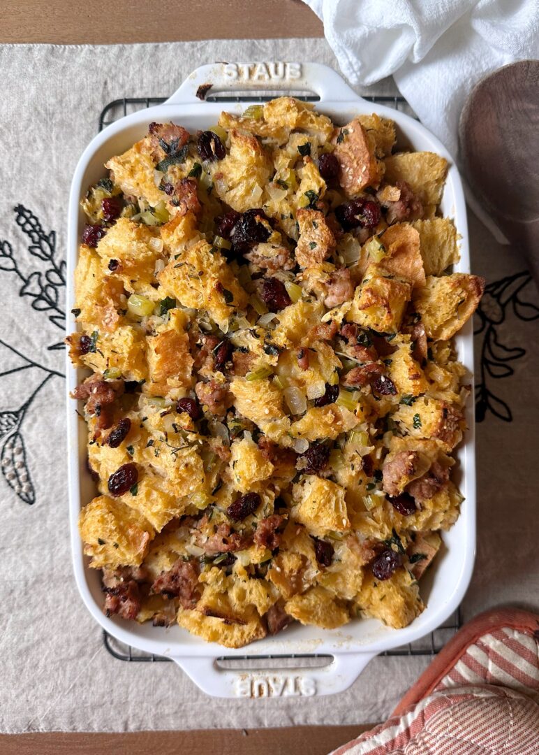 sausage and cranberry stuffing in white casserole dish