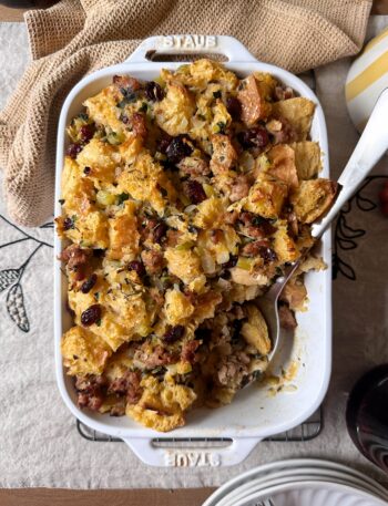 sausage and cranberry stuffing with silver serving spoon