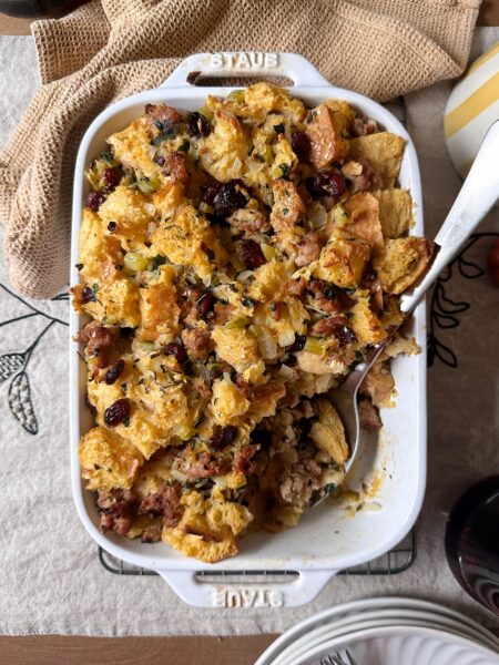 sausage and cranberry stuffing with silver serving spoon