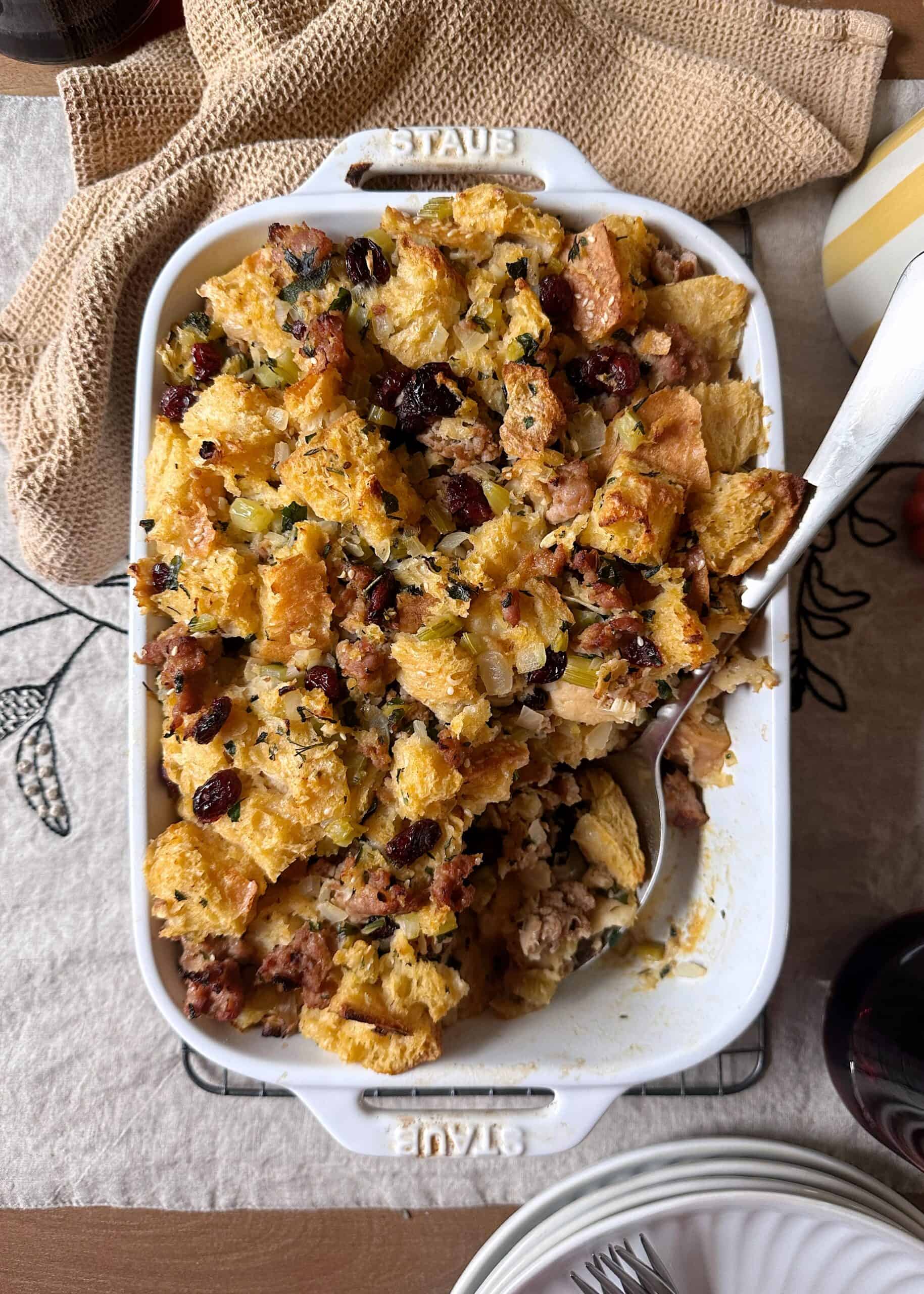 sausage and cranberry stuffing with silver serving spoon