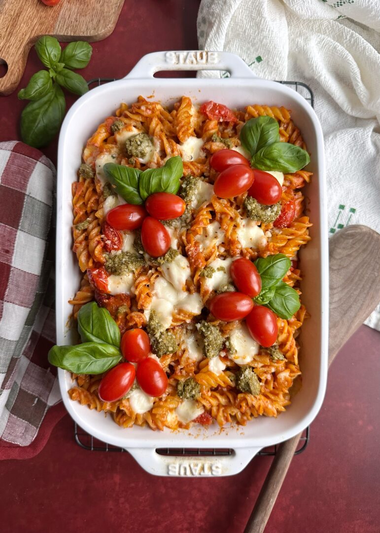 baked christmas pasta with cherry tomato and basil garnish