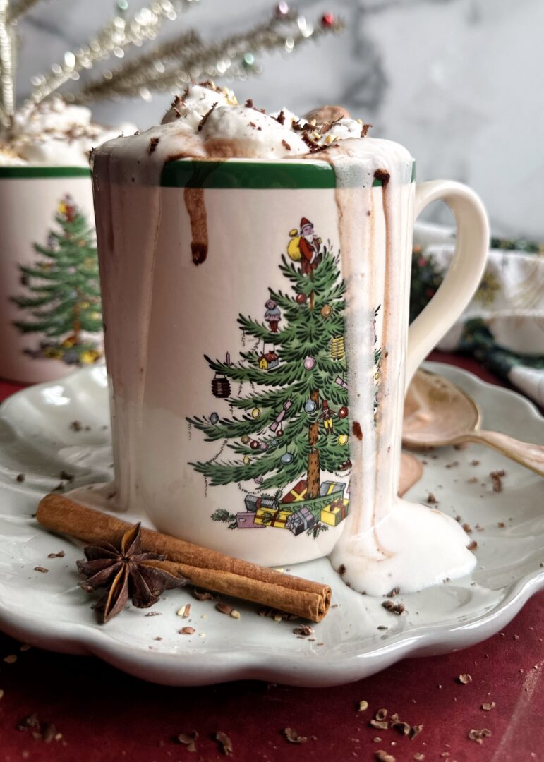 spiced tahini hot chocolate with whipped cream in a christmas mug