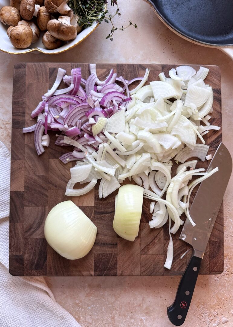 sliced red and yellow onions on wooden cutting board